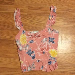 A pink top w colorful flowers